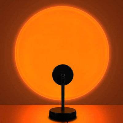 a black table lamp sitting on top of a table