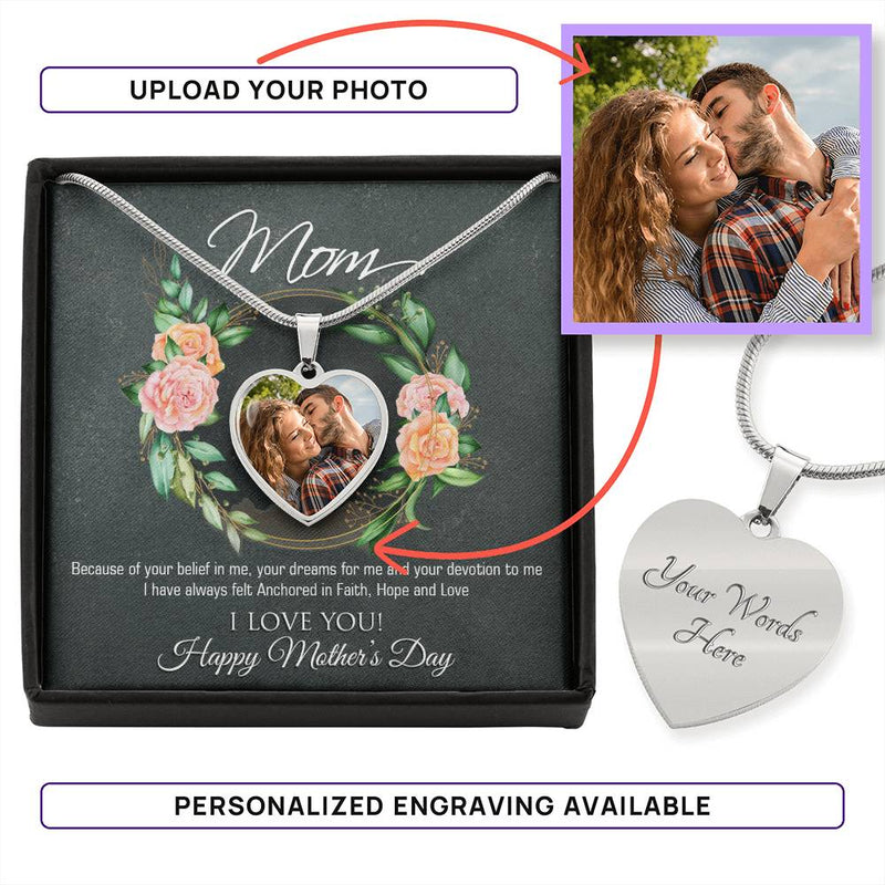 a heart shaped necklace with a photo of a couple