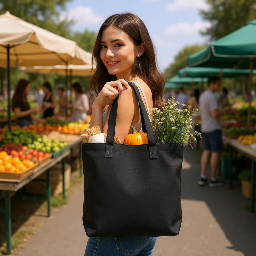 Canvas Tote Bag – 16x14 Inches, Personalized, Black in a farmer's market, carrying fresh produce, natural lighting