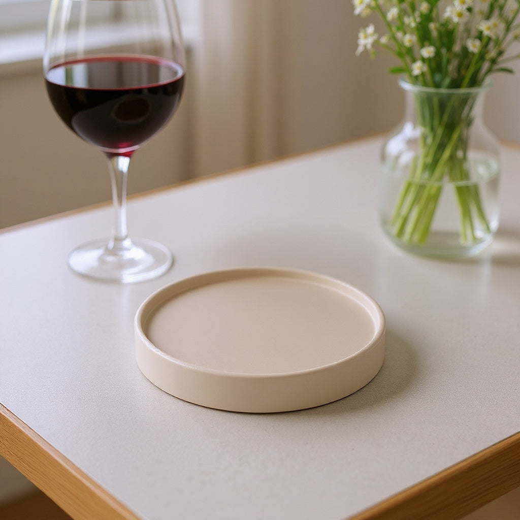 Ceramic Photo Coaster displayed on a kitchen countertop with plants and books, editorial style